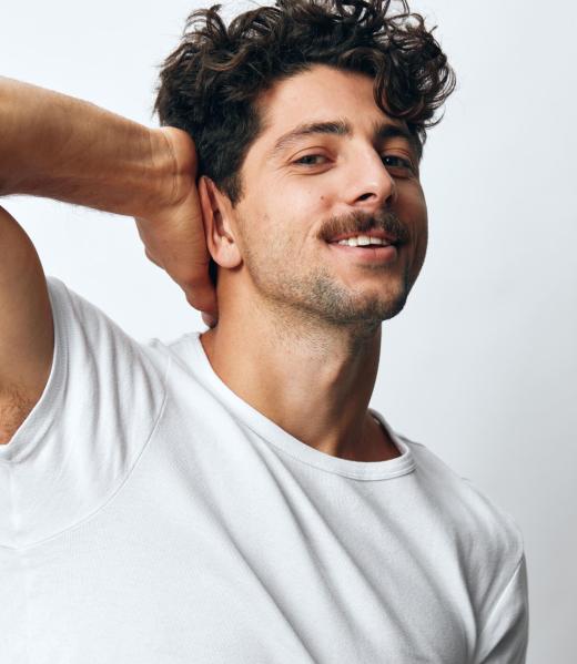 Lifestyle man t-shirt modern casual white standing smile background happy person adult portrait one fashion emotion cool attire happiness isolated closeup serious hipster idea model